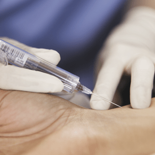 Image of a physician taking a blood sample